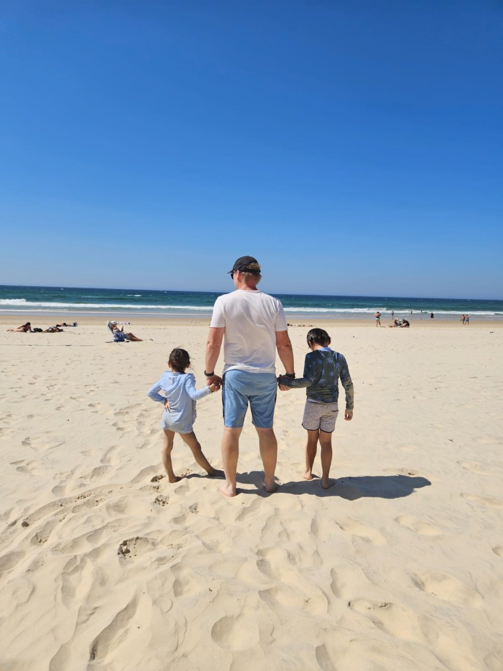 Michael with his two children on an Australian beach